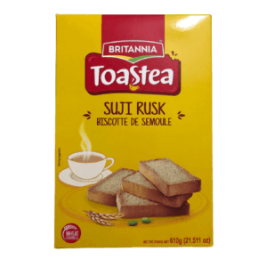 Box of Britannia Toast Tea Suji Rusk biscuits on bright yellow packaging, showing stacked rusks and a steaming cup of tea. - Britannia Toastea Suji Rusk 610G