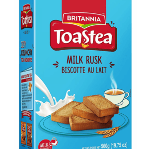 Britannia ToastTea Milk Rusk box in blue with a stack of rusks and a steaming cup of tea nearby - Britannia Toastea Milk Rusk 560G