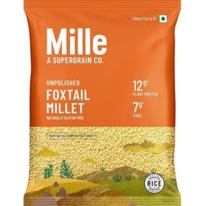 Package of Millet foxtail millet flour/grain: orange bag with 'Mille' branding and nutrition facts (12g protein, 7g fibre) visible, rice-like millet inside panel artwork (100% gluten free) - Mille Foxtail Millet 500gm
