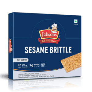 Box of Sesame Brittle cereal/snack labeled 'Rich in Traditions' with sesame slab partially visible on the right side - Jabsons Chikki Sesame (Brittle) 40gm