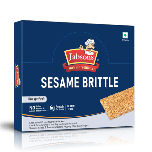 Box of Sesame Brittle cereal/snack labeled 'Rich in Traditions' with sesame slab partially visible on the right side