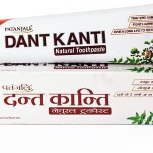 Toothpaste tube labeled Dant Kanti natural toothpaste resting on its box with Hindi text and botanical graphics. - Patanjali Dant kanti Tooth Paste 100gm