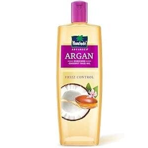 Conditioner bottle labeled Argan Coconut Oil Care Frizz Control with a purple cap - Parachute Adv Argan Enriched Coconut Hair Oil 200ml