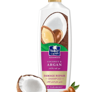 Shampoo bottle labeled Coconut & Argan for damage repair with a halved coconut and argan nuts nearby. - Parachute Adv Coconut & Argan Shampoo 340ml