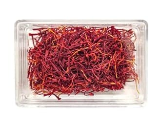 Saffron threads in a clear plastic container, rich red-orange in color. - Saffron – 1G